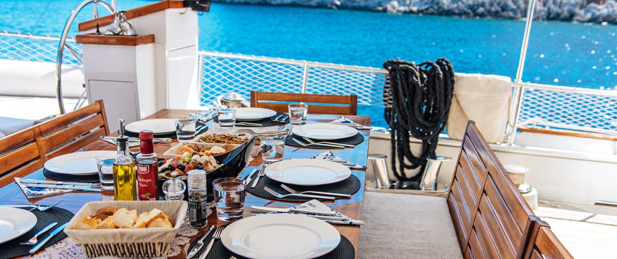 Lunch laid out on the deck table of a wooden gulet