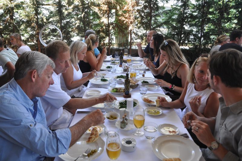 A long table laid for lunch under the trees