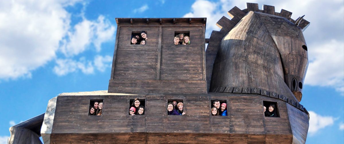 A group looking out from the windows of the wooden horse at Troy